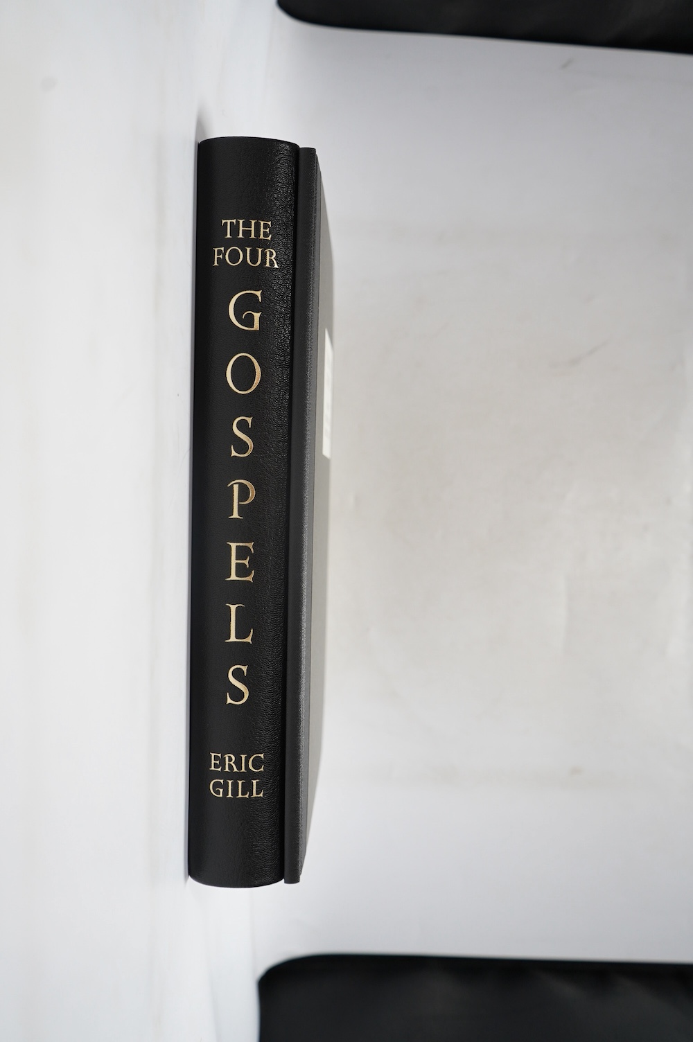 Folio Society - Gill, Eric - The Four Gospels, one of 2750, monochrome illustrations, all edges gilt, original gilt decorated full black morocco in black cloth drop box, includes Essays, by John Dreyfus & Robert Gibbings